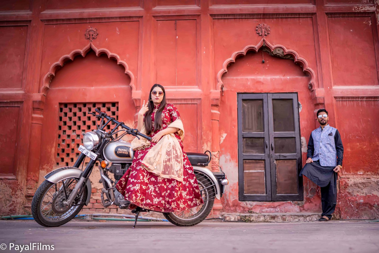 Stylish couple pre-wedding photoshoot posing with Royal Enfield motorcycle by Payal Films Bihar