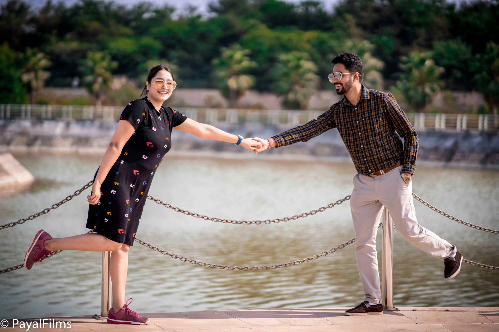 A playful couple holding hands and laughing during a pre-wedding shoot by Payal Films in Khagaria.
