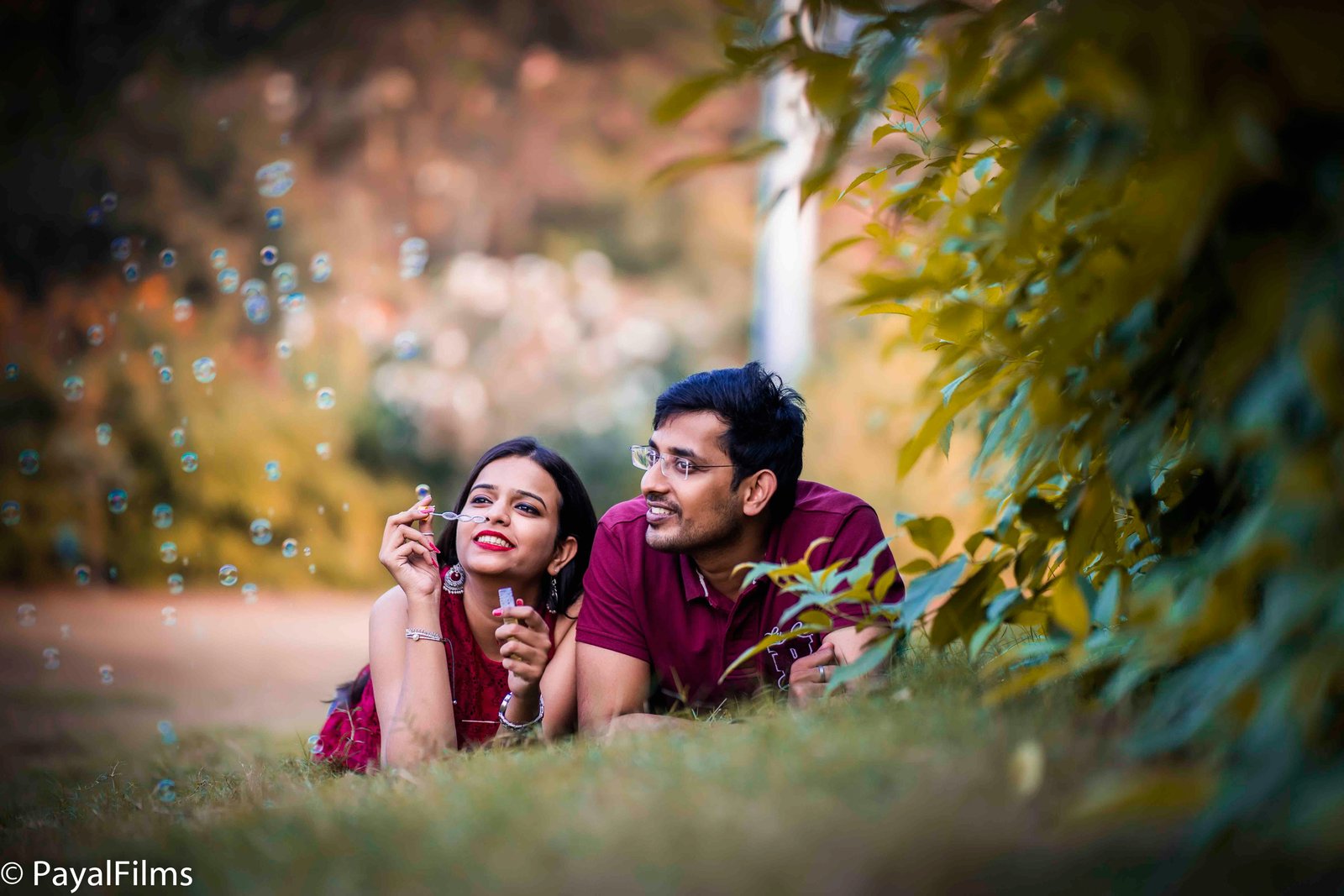 Romantic pre-wedding couple blowing bubbles on grass captured by Payal Films Khagaria