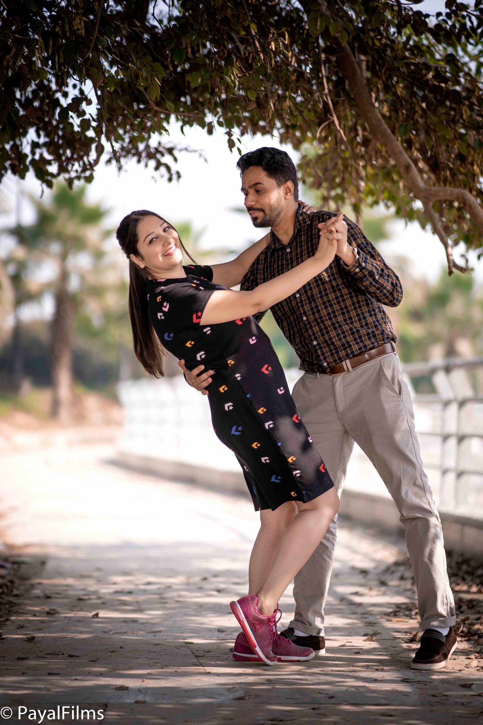 A romantic couple holding an I love you sign during a pre-wedding shoot in Khagaria by Payal Films.