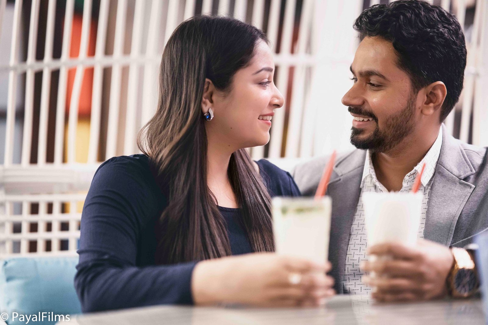 Romantic couple smiling and looking at each other during a cafe date, captured by Payal Films in Khagaria.