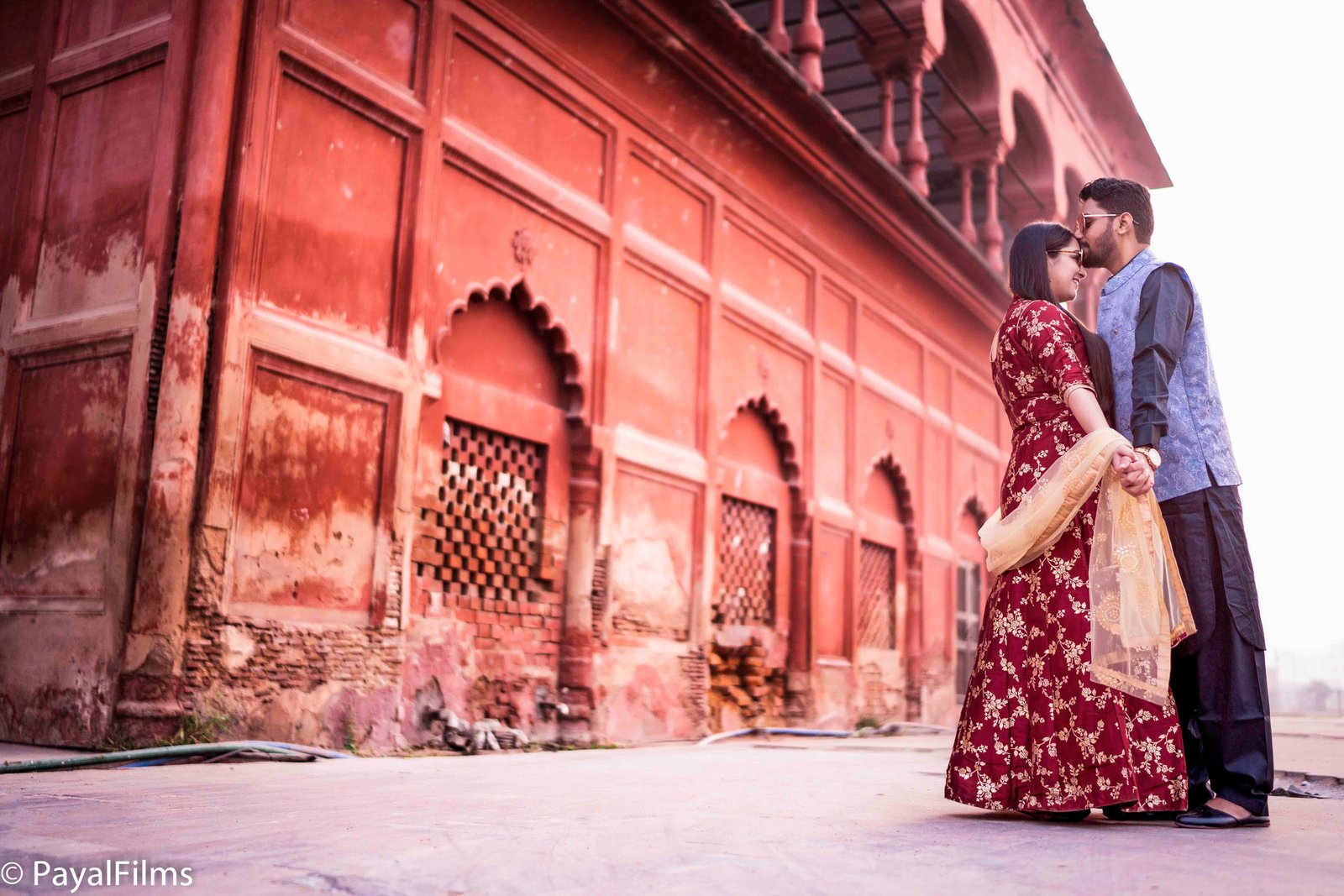 Emotional groom kissing bride's forehead in traditional wedding attire by Payal Films Bihar