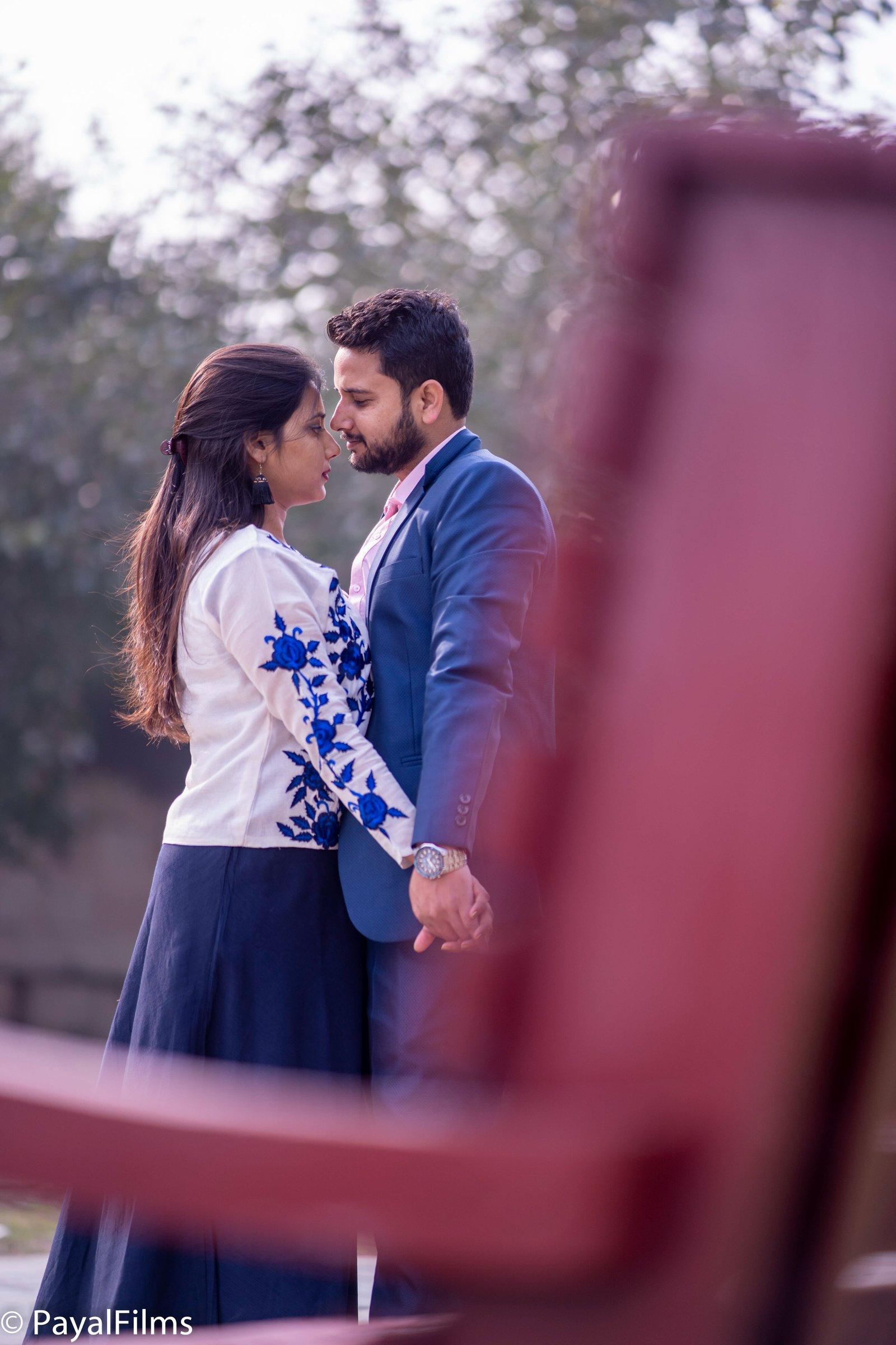Romantic couple holding hands in matching blue attire captured by Payal Films in Khagaria.