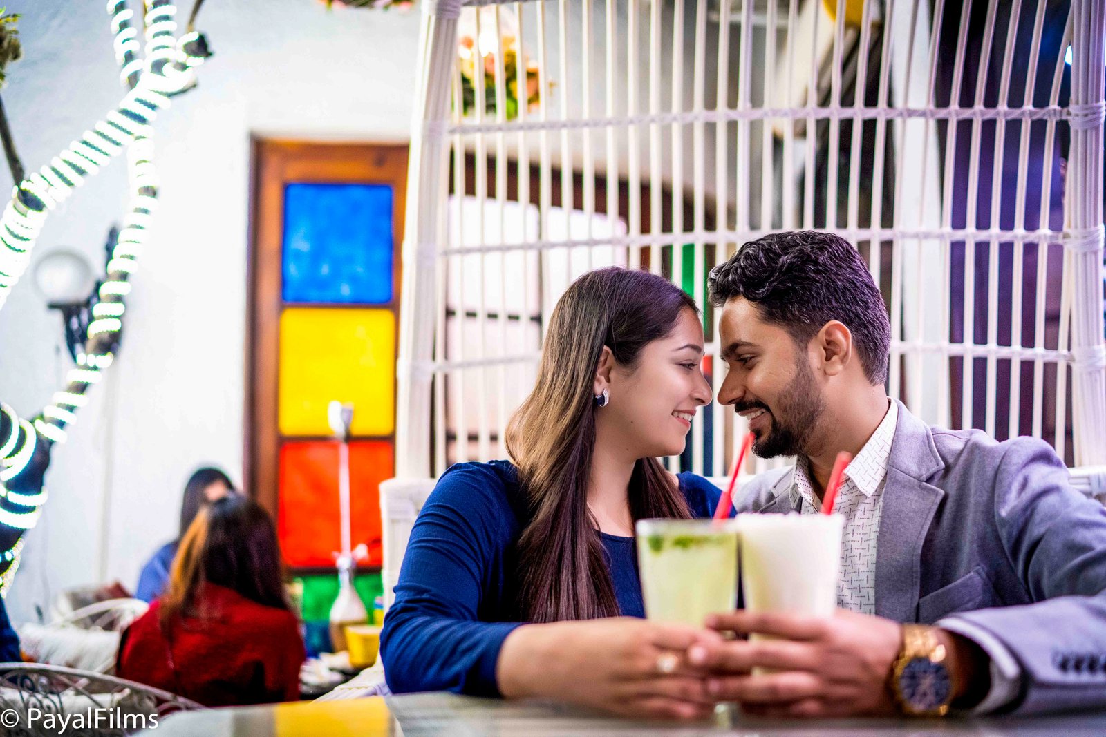Romantic couple sharing drinks on a cafe date captured by Payal Films in Khagaria.