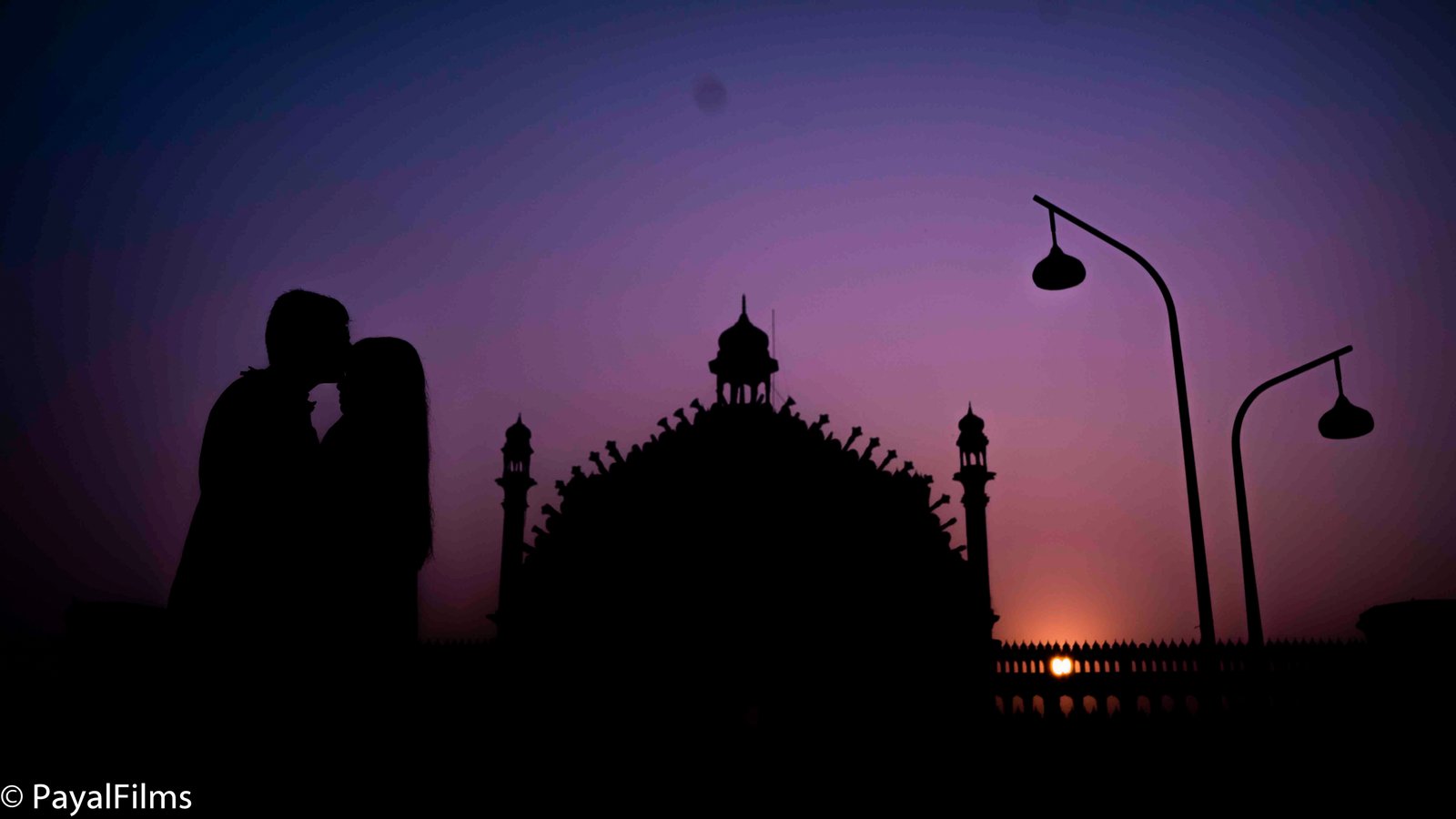 Romantic couple silhouette at sunset against historic architecture captured by Payal Films in Khagaria.
