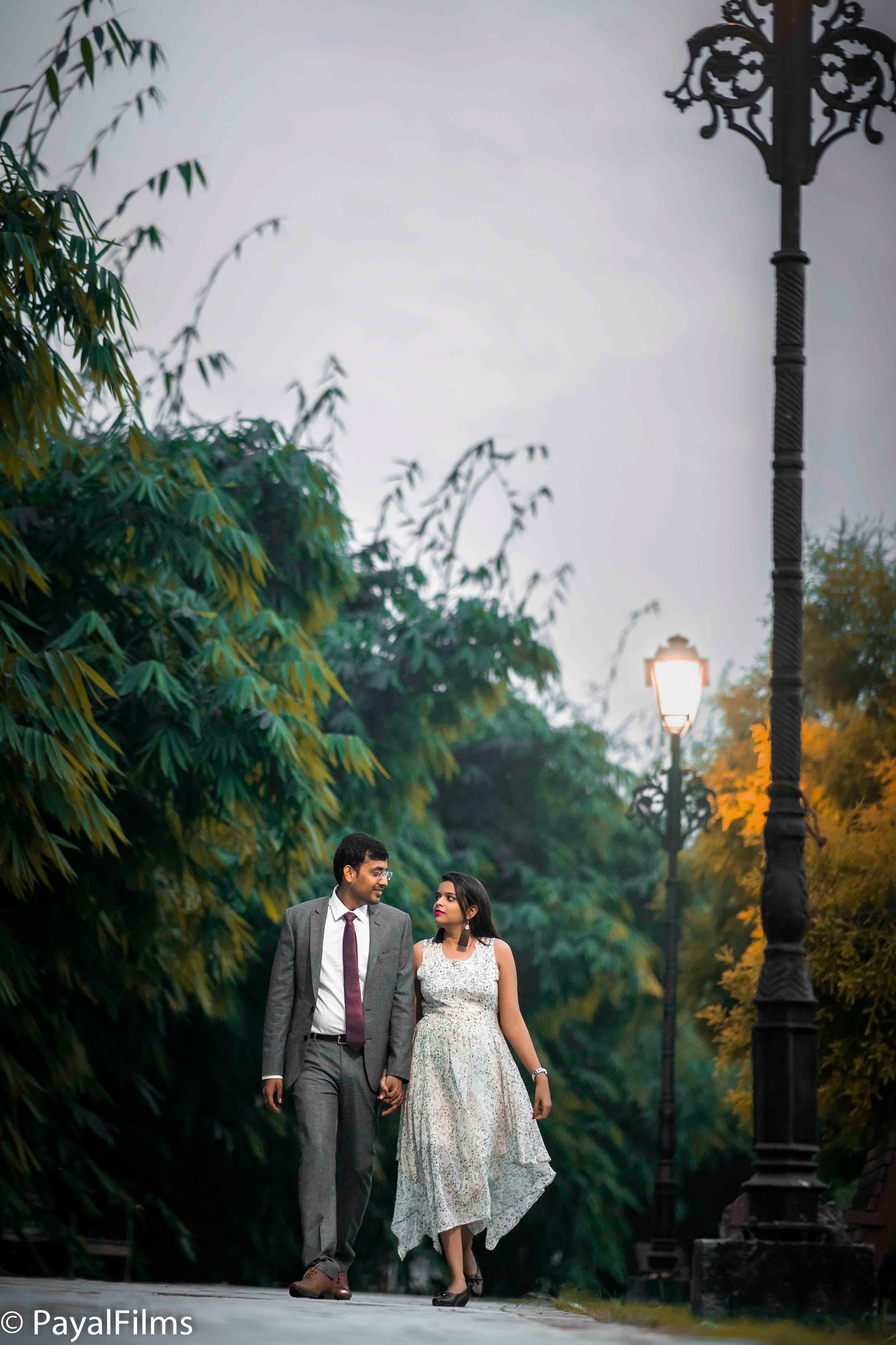 Romantic couple walking and holding hands in a park, captured by Payal Films in Khagaria.