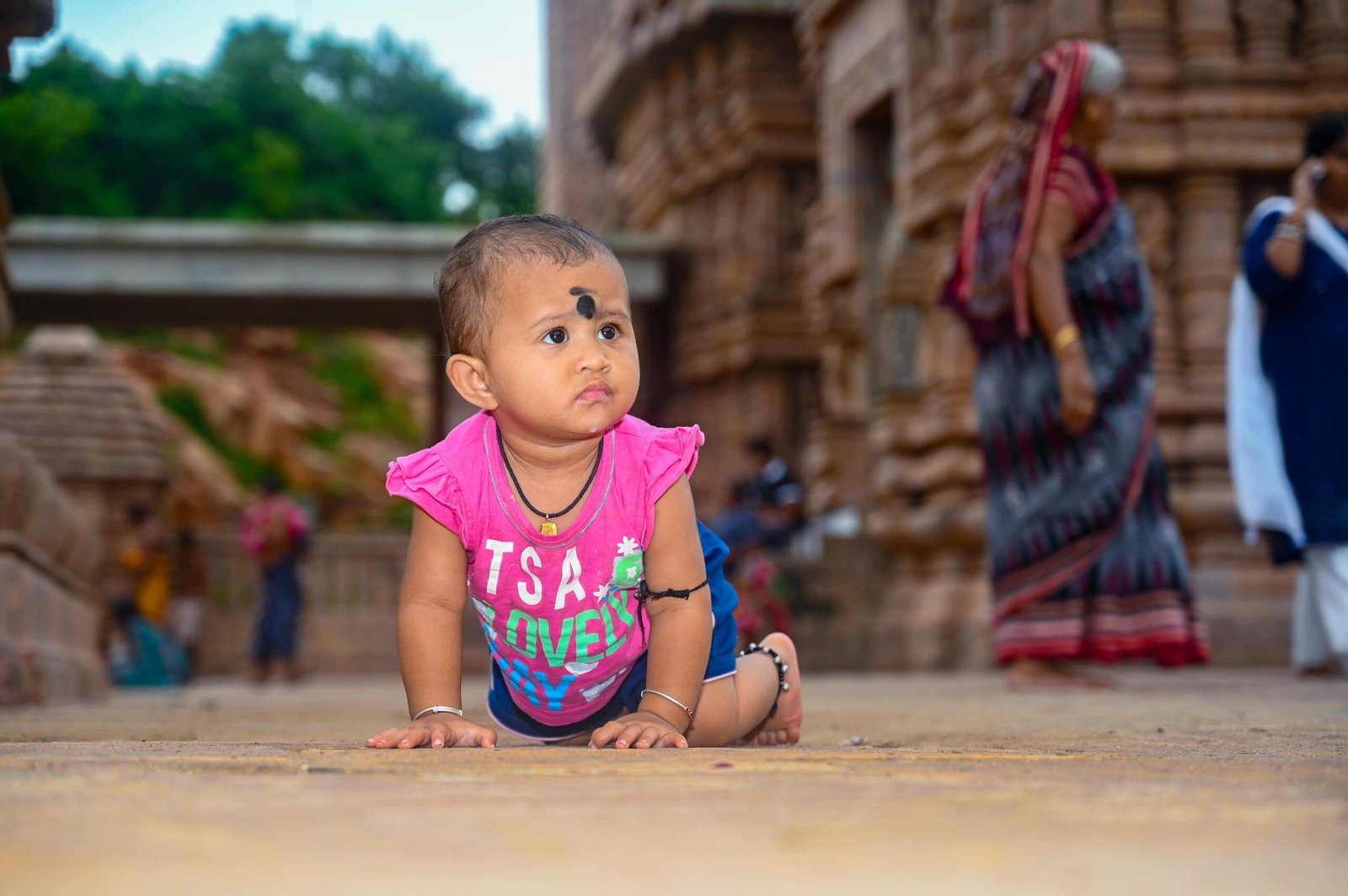 baby crawling stone structure traditional attire - Payal Films Bihar