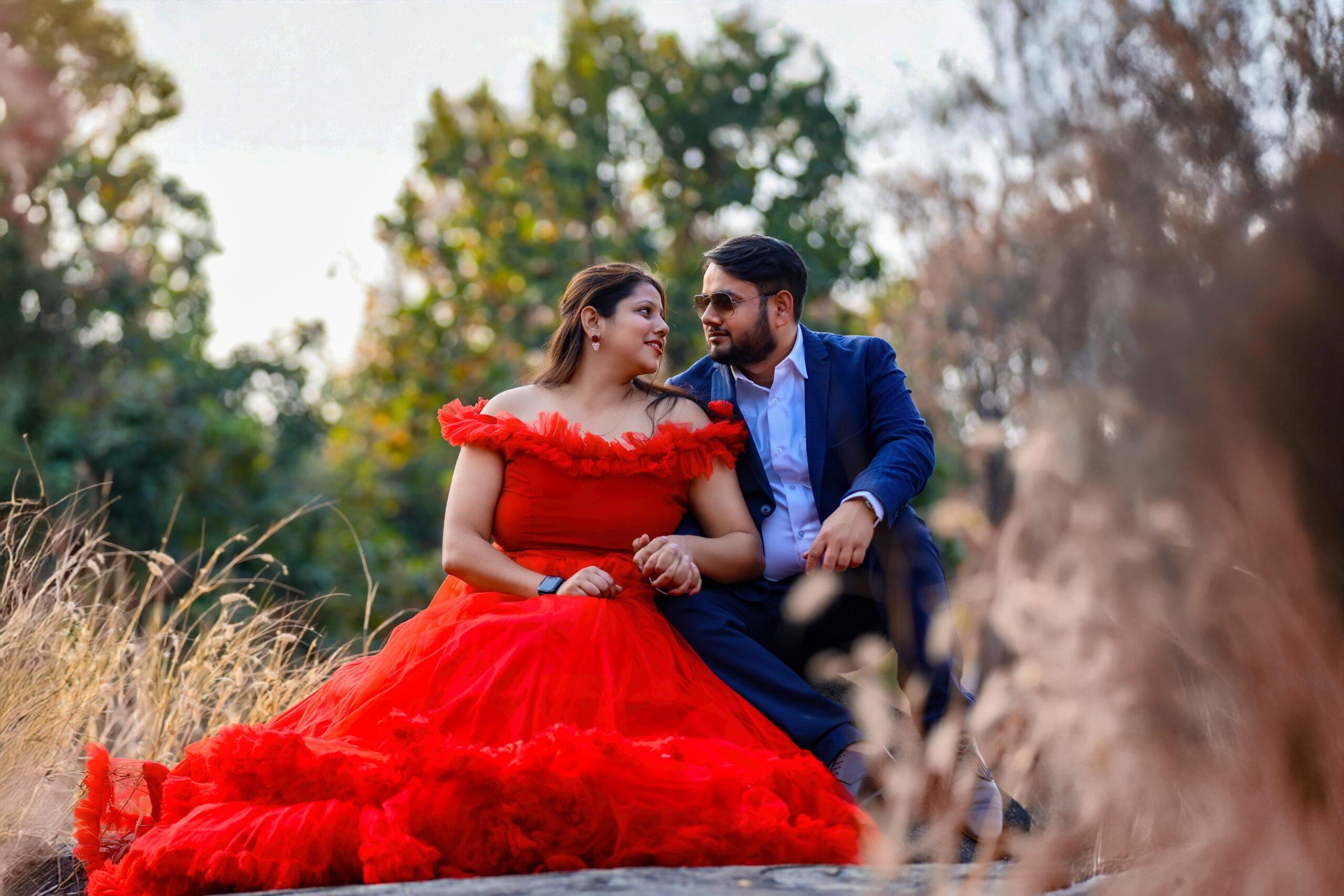 couple outdoors red gown blue suit