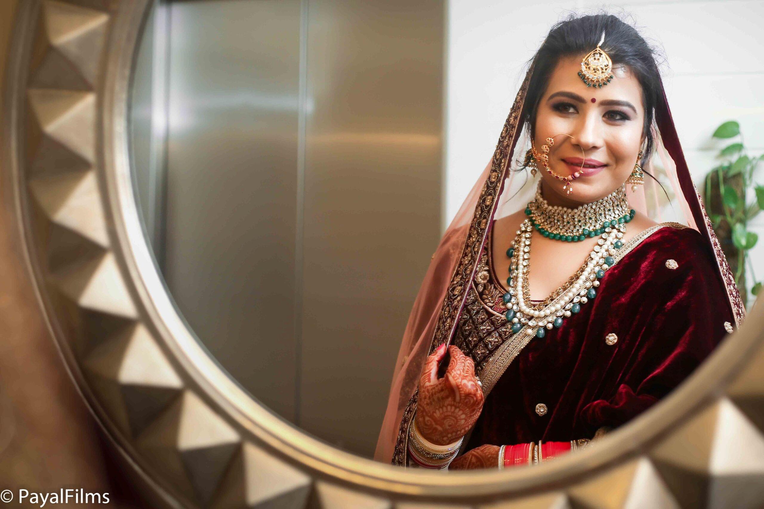 Payal Films artistic bridal portrait in traditional attire reflected in mirror at wedding venue, Bihar