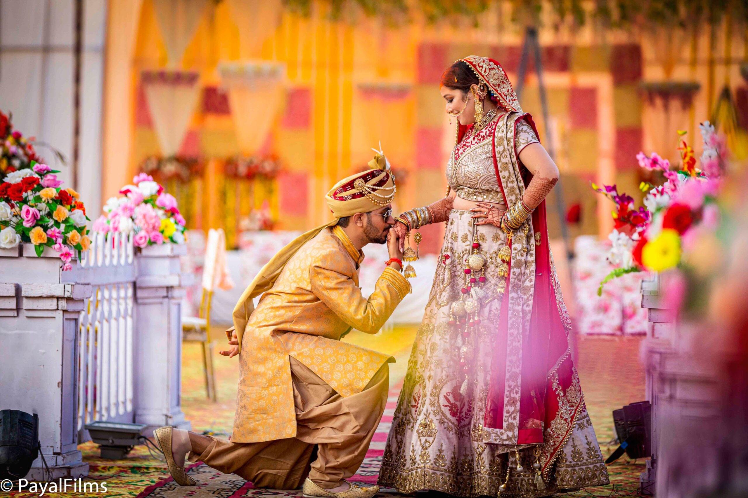 Payal Films groom proposing to bride in regal attire during Bihar outdoor wedding ceremony