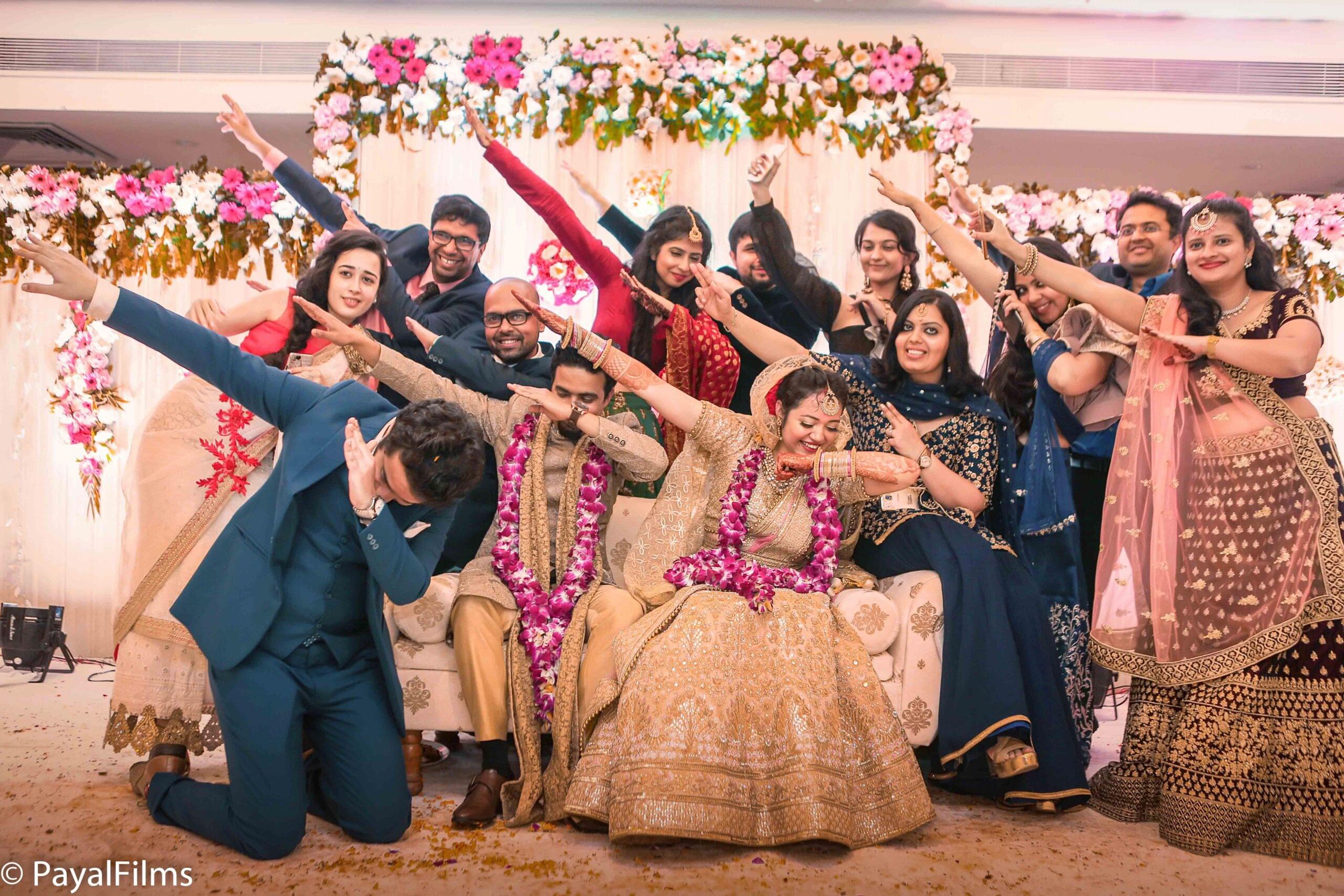 Payal Films candid wedding moment with bride and groom posing with friends in celebration, Khagaria