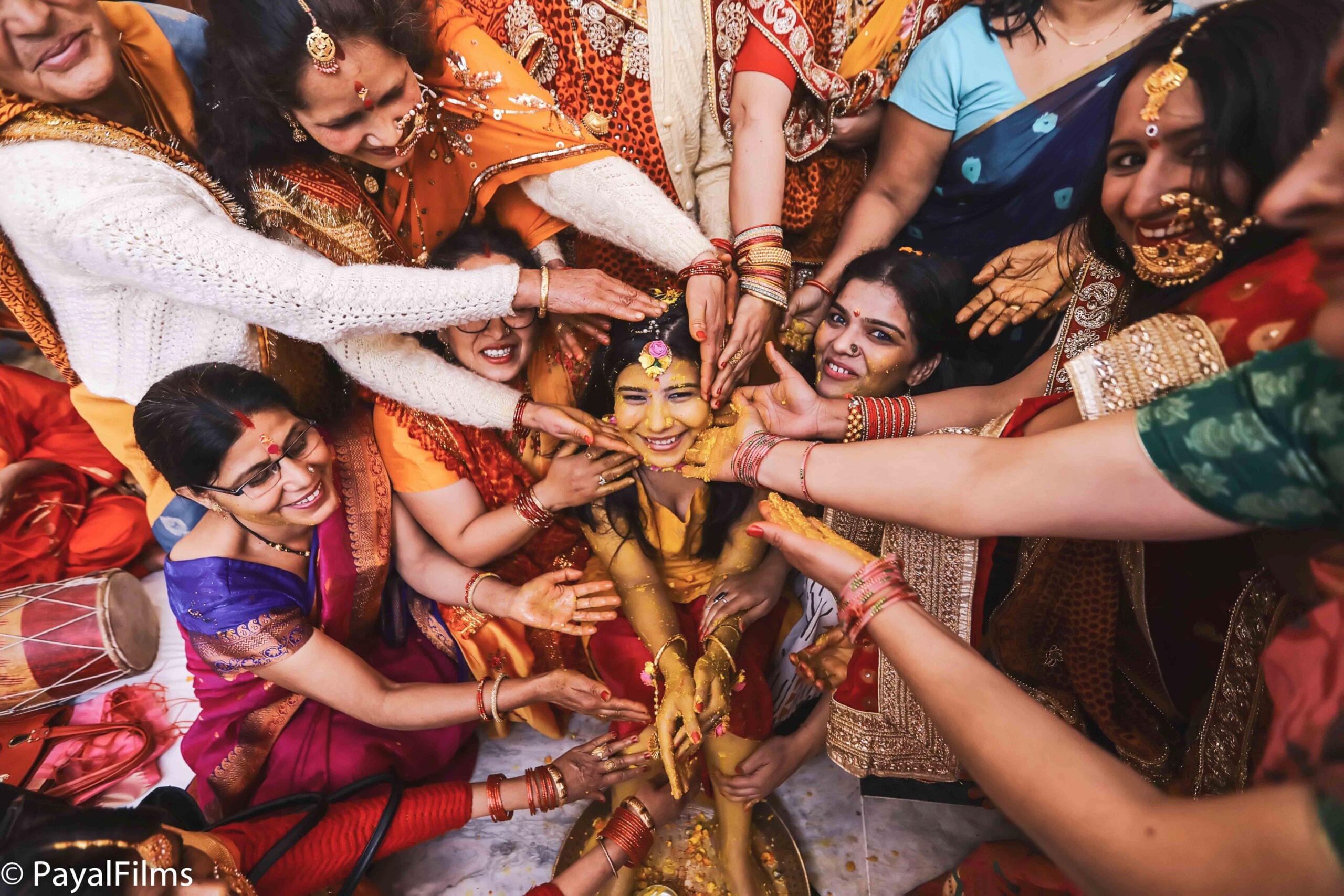 Payal Films vibrant haldi ceremony with family participating in ritual celebration, BiharPayal Films vibrant haldi ceremony with family participating in ritual celebration, Bihar