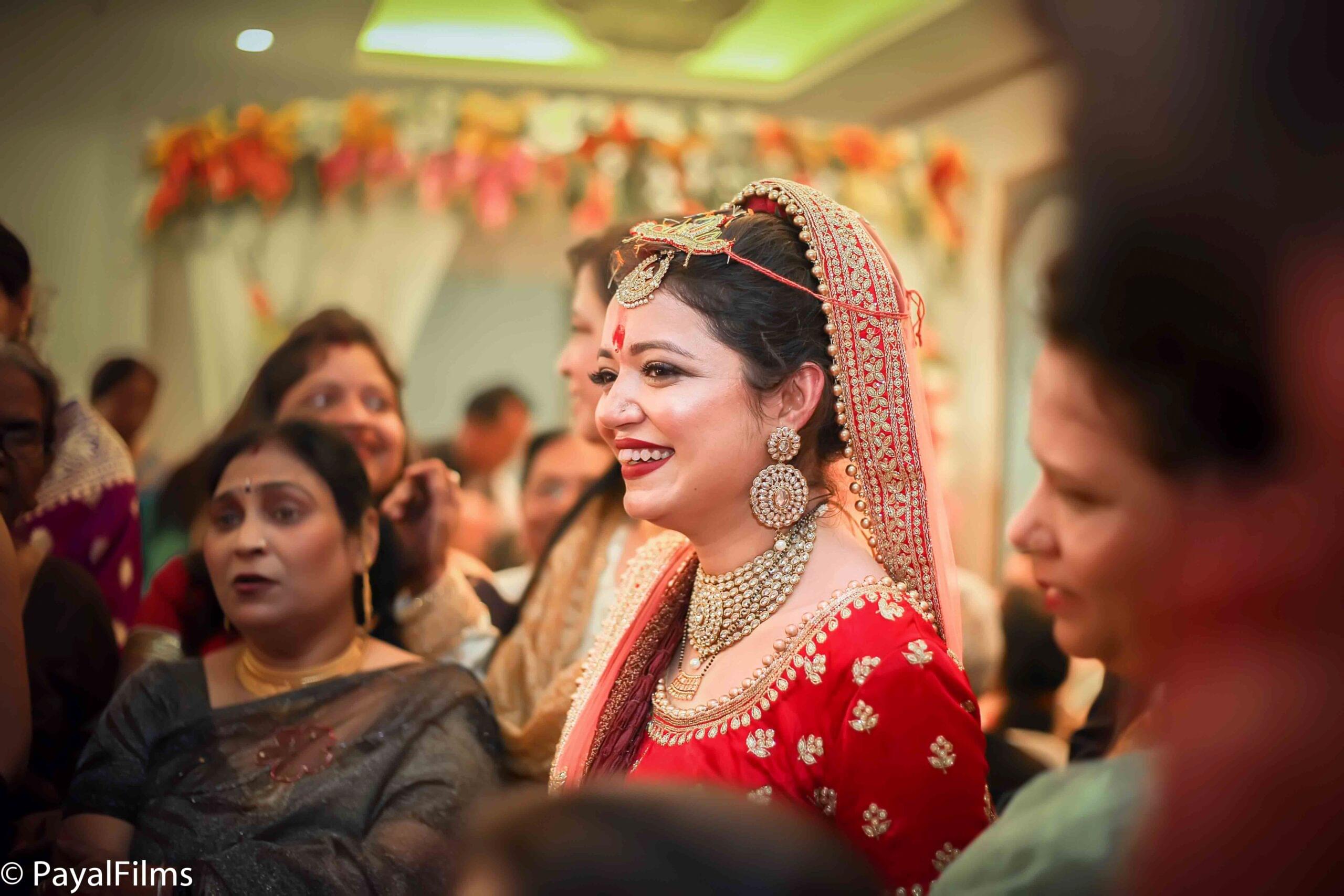 Payal Films bride dressed in traditional red wedding attire with family at Khagaria ceremony