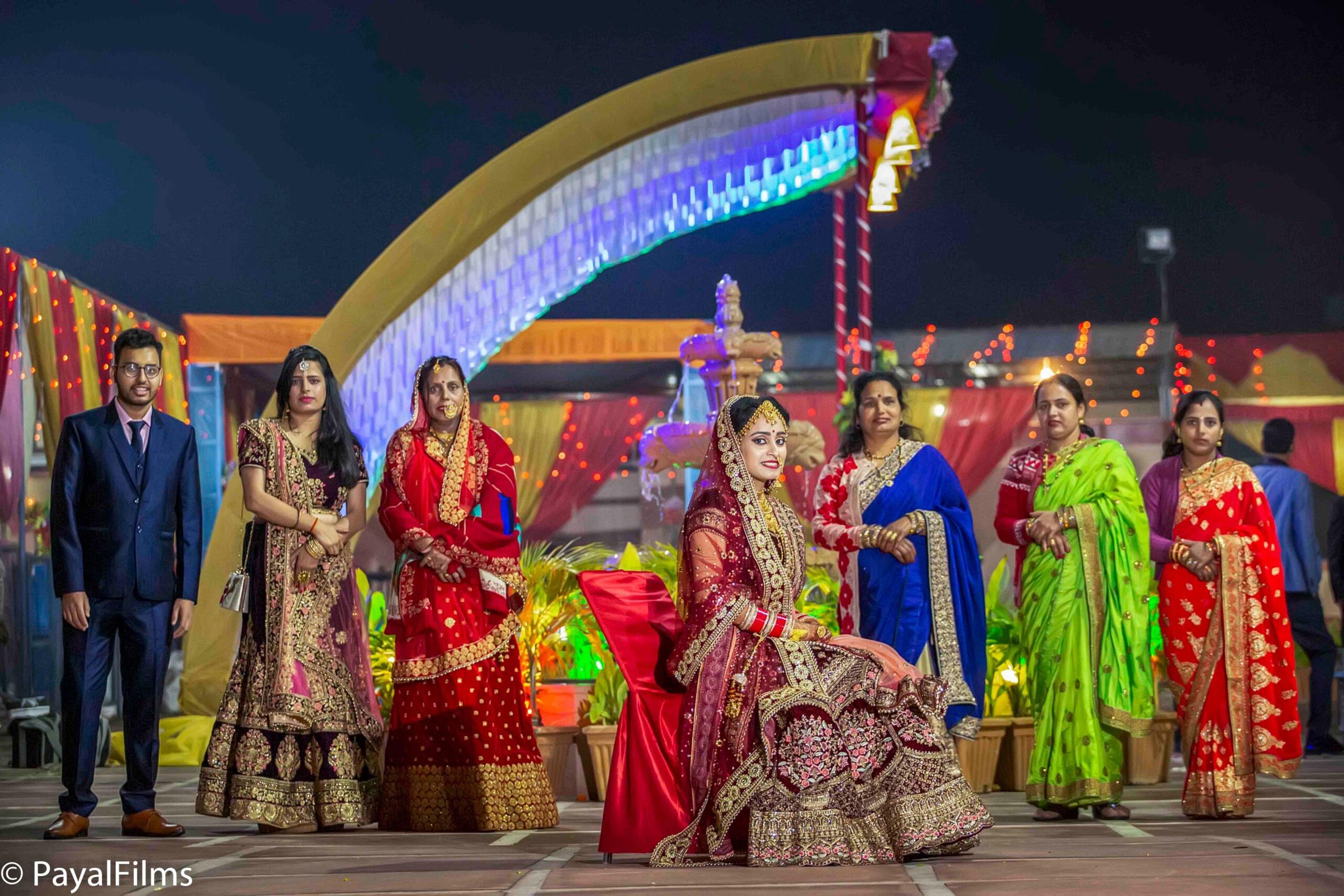 Payal Films wedding family group in colorful traditional outfits at night ceremony in Khagaria