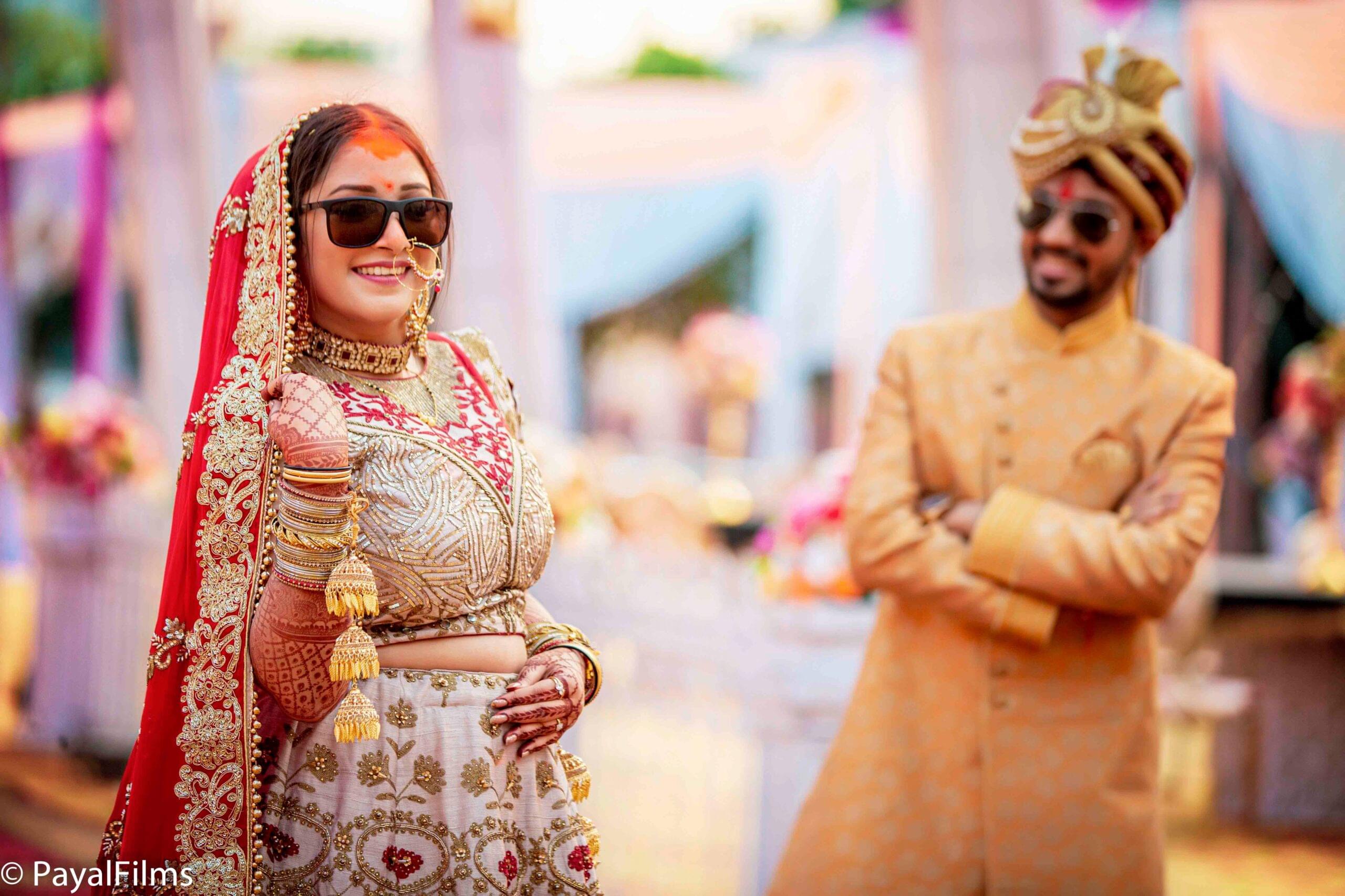 Payal Films wedding couple in regal gold and red attire posing during traditional Bihar ceremony