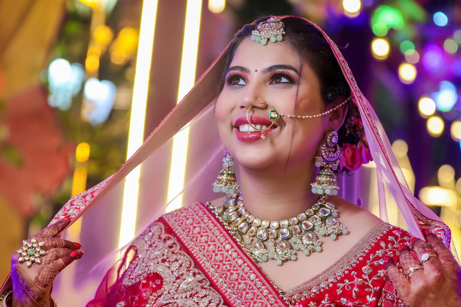 Traditional Indian bridal portrait in authentic red lehenga and jewelry by Payal Films Bihar