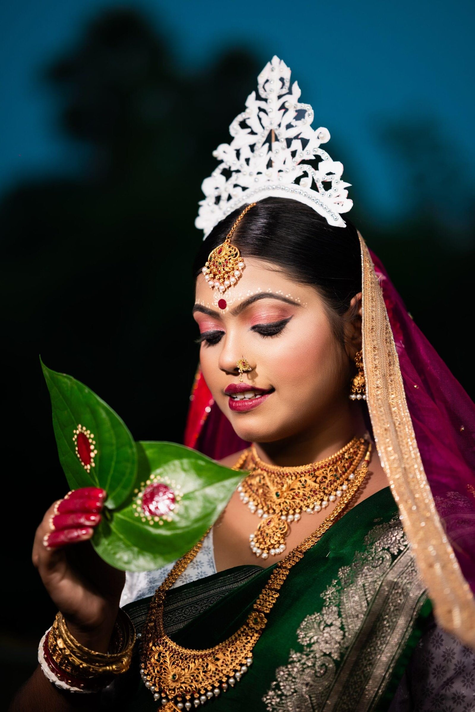 Wedding bride in green saree wearing gold jewelry and pink dupatta in Khagaria, Bihar. Traditional Indian bridal portrait - Payal Films Bihar